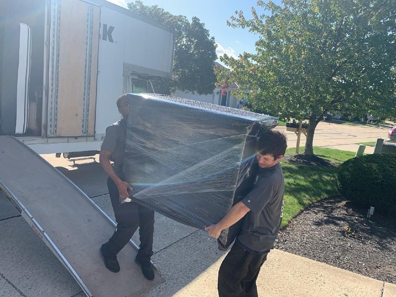 movers loading furniture into a truck
