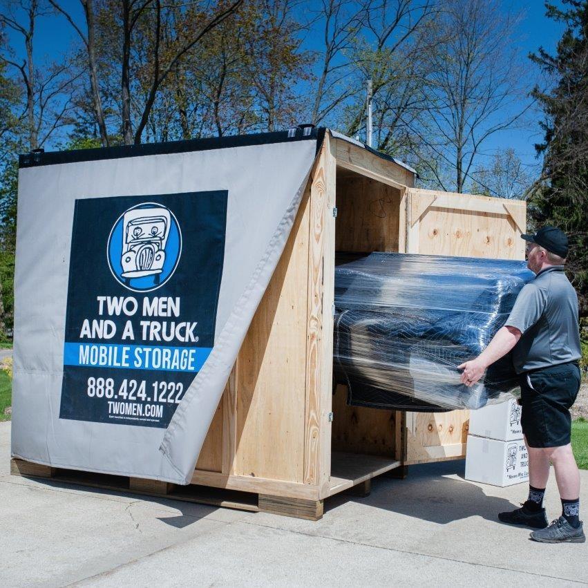 Movers loading items into Mobile Storage container