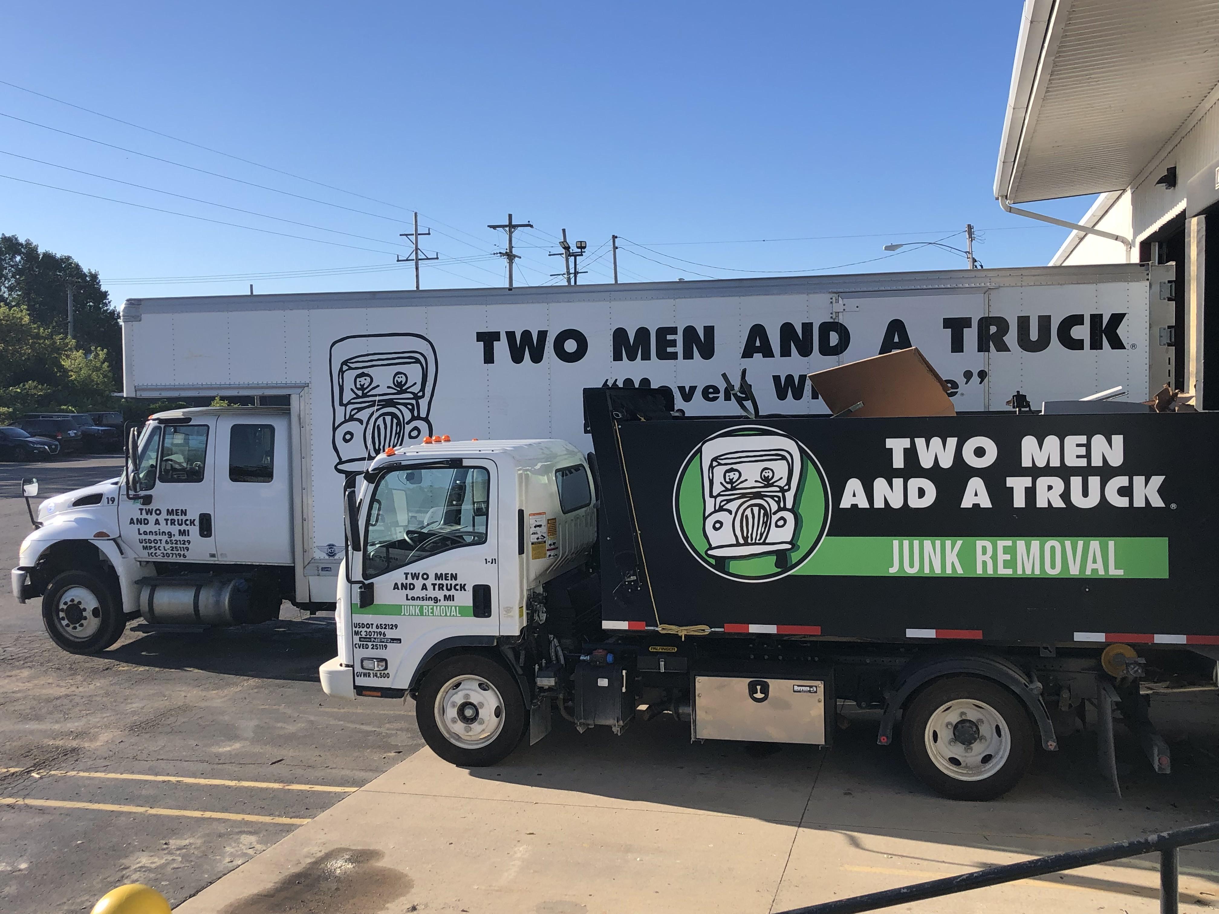 Our green and black junk truck next to our 26 foot moving truck