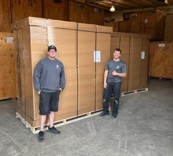 two movers in front of crates